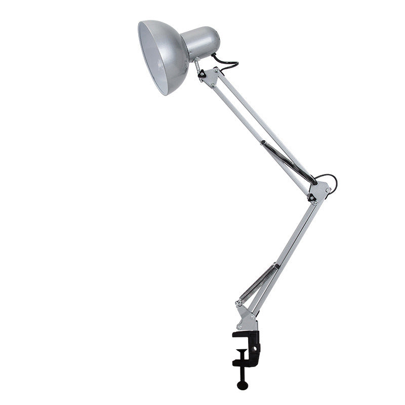 Clip-mount table lamp clamped to a desk edge in a workspace.