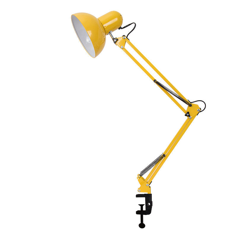 Clip-mount table lamp clamped to a bedside headboard.