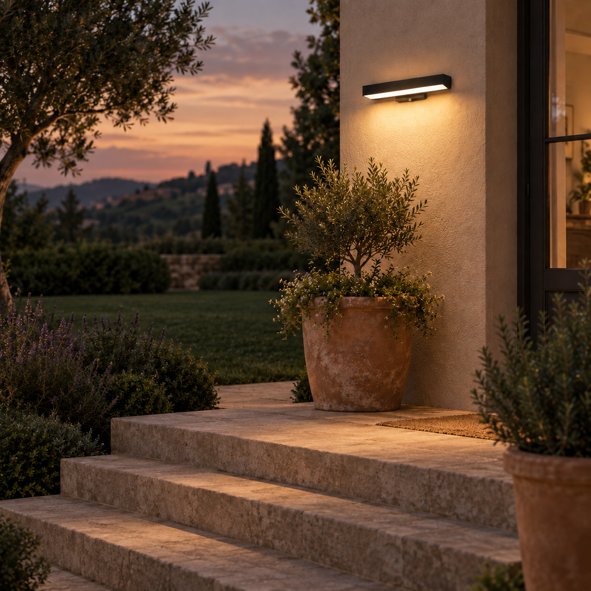 Caminha linear outdoor wall light, in a garden.