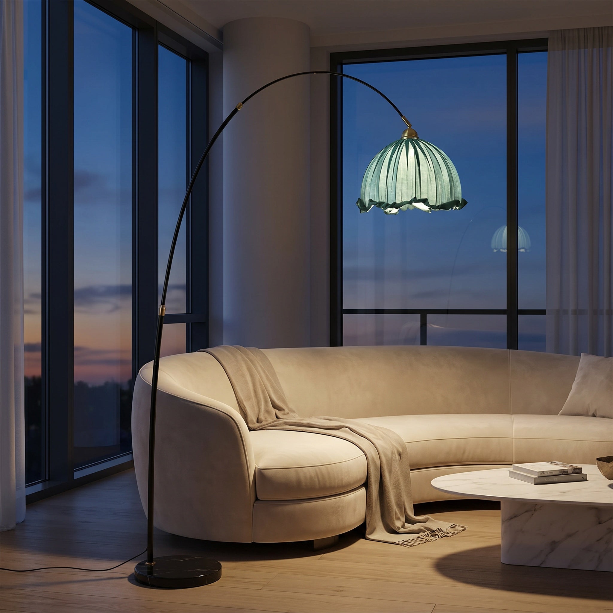 Arc floor lamp with blue scalloped shade above a curved beige sofa at dusk with city skyline.