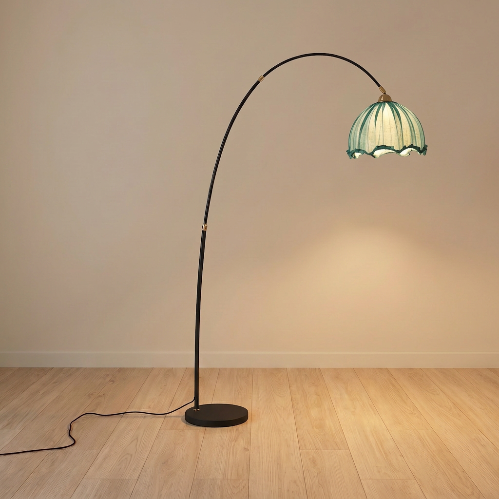 Arc floor lamp with black stem and blue scalloped fabric shade on a black marble base, product shot.