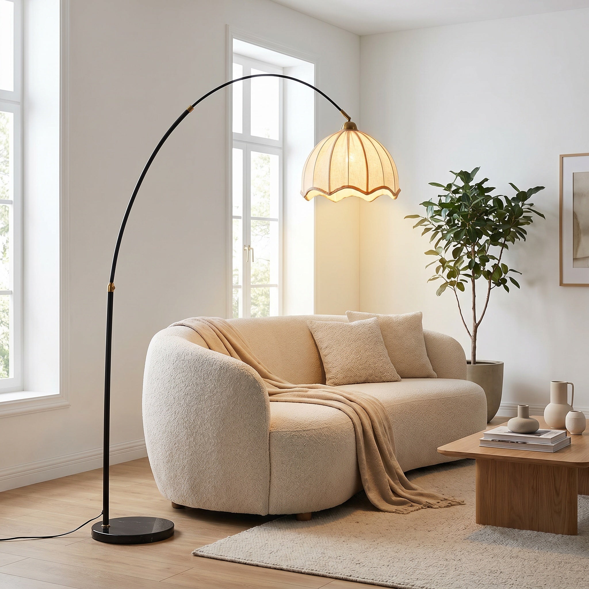 Arc floor lamp with white scalloped shade beside a boucle sofa in a bright daylight living room.
