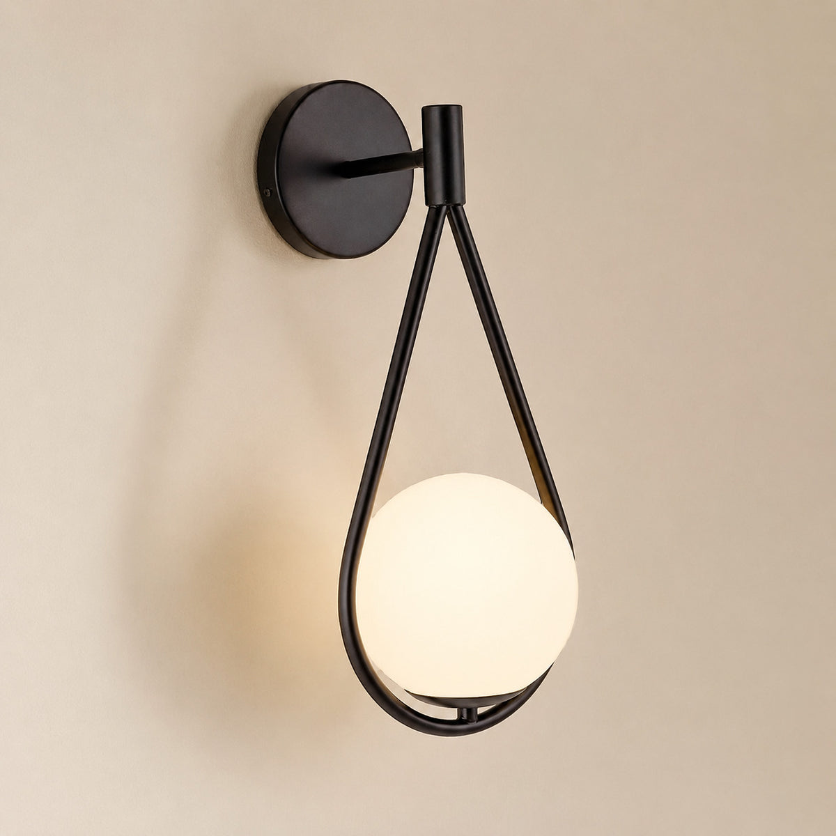 Celorico loop wall sconce with a matte black teardrop and an opal white globe