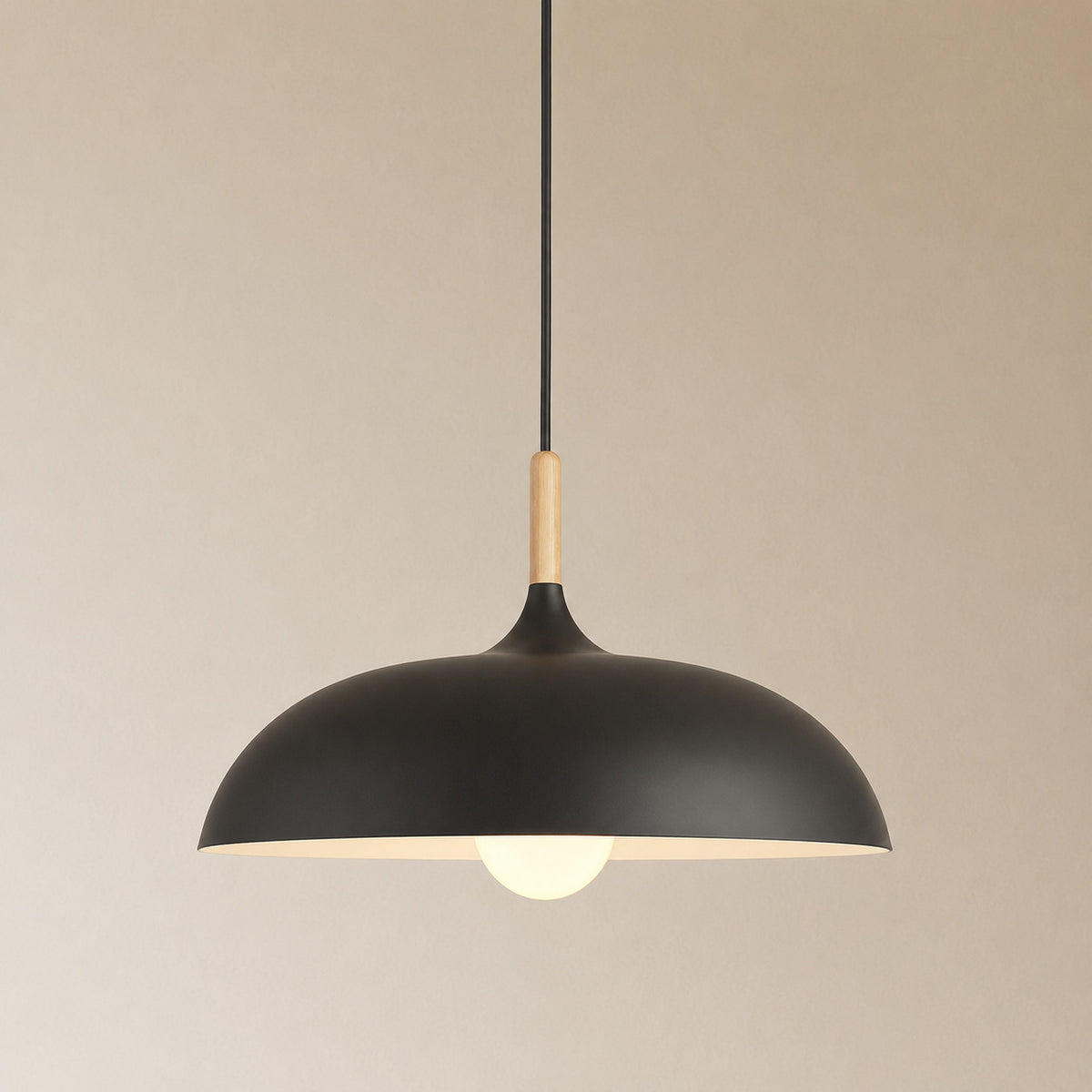 Cobres pendant in matte black with a turned wood cap, the wide shallow Flat Sphere shade