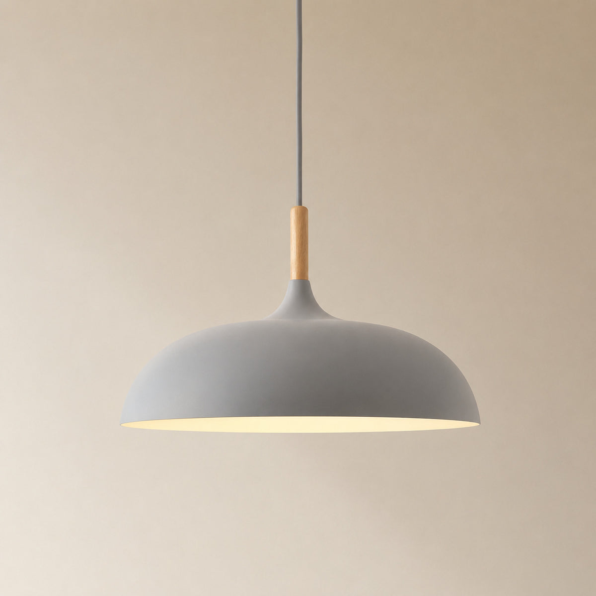 Cobres pendant in mid warm grey with a turned wood cap, the wide shallow Flat Sphere shade