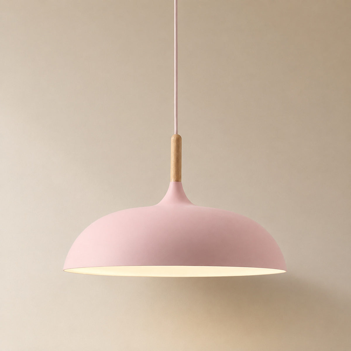 Cobres pendant in soft rose pink with a turned wood cap, the wide shallow Flat Sphere shade