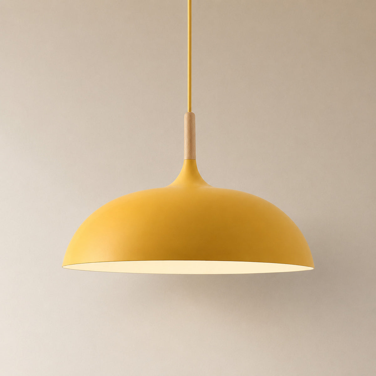 Cobres pendant in warm marigold orange-yellow with a turned wood cap, the wide shallow Flat Sphere shade
