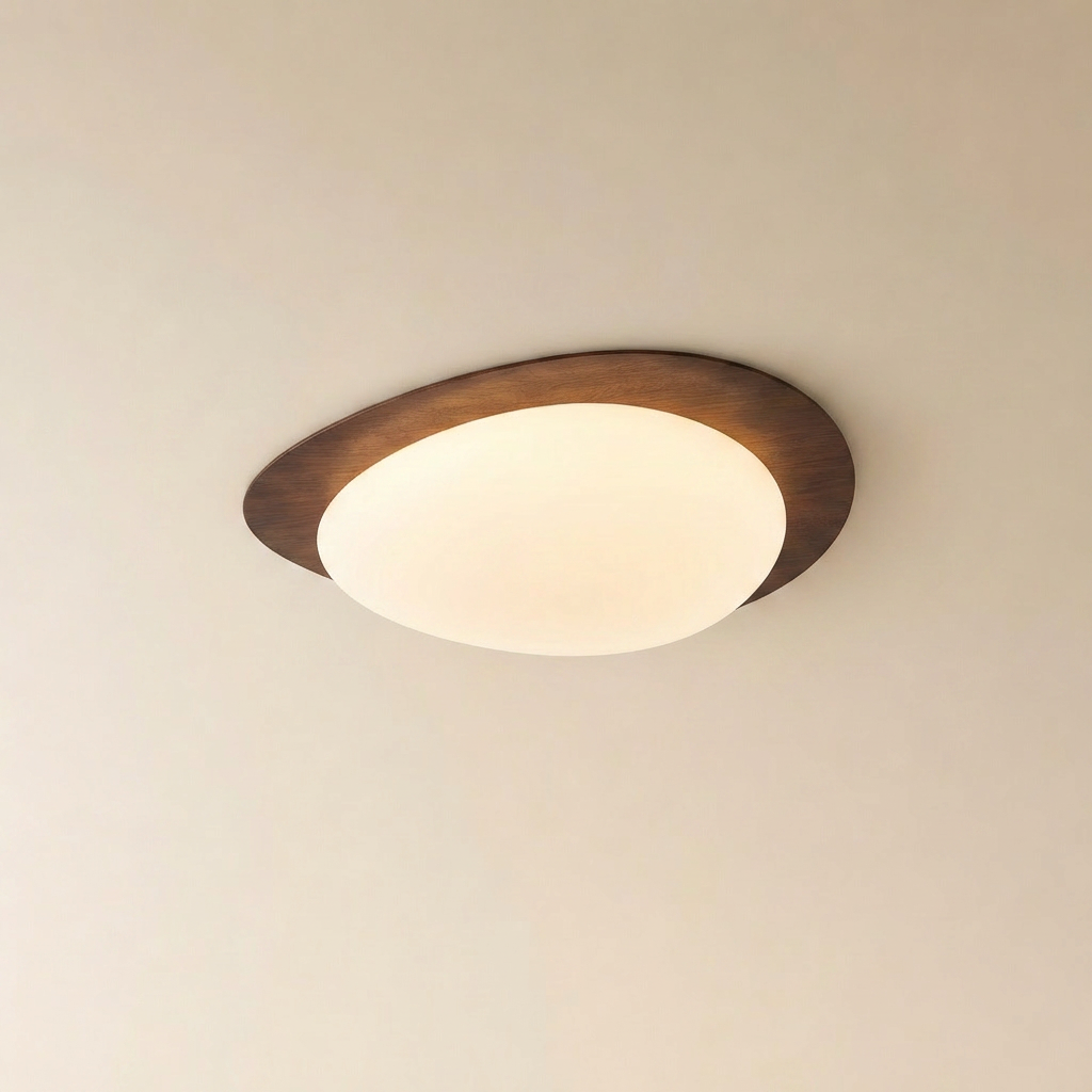 Ericeira pebble form flush mount ceiling light glowing warm above a cosy living room