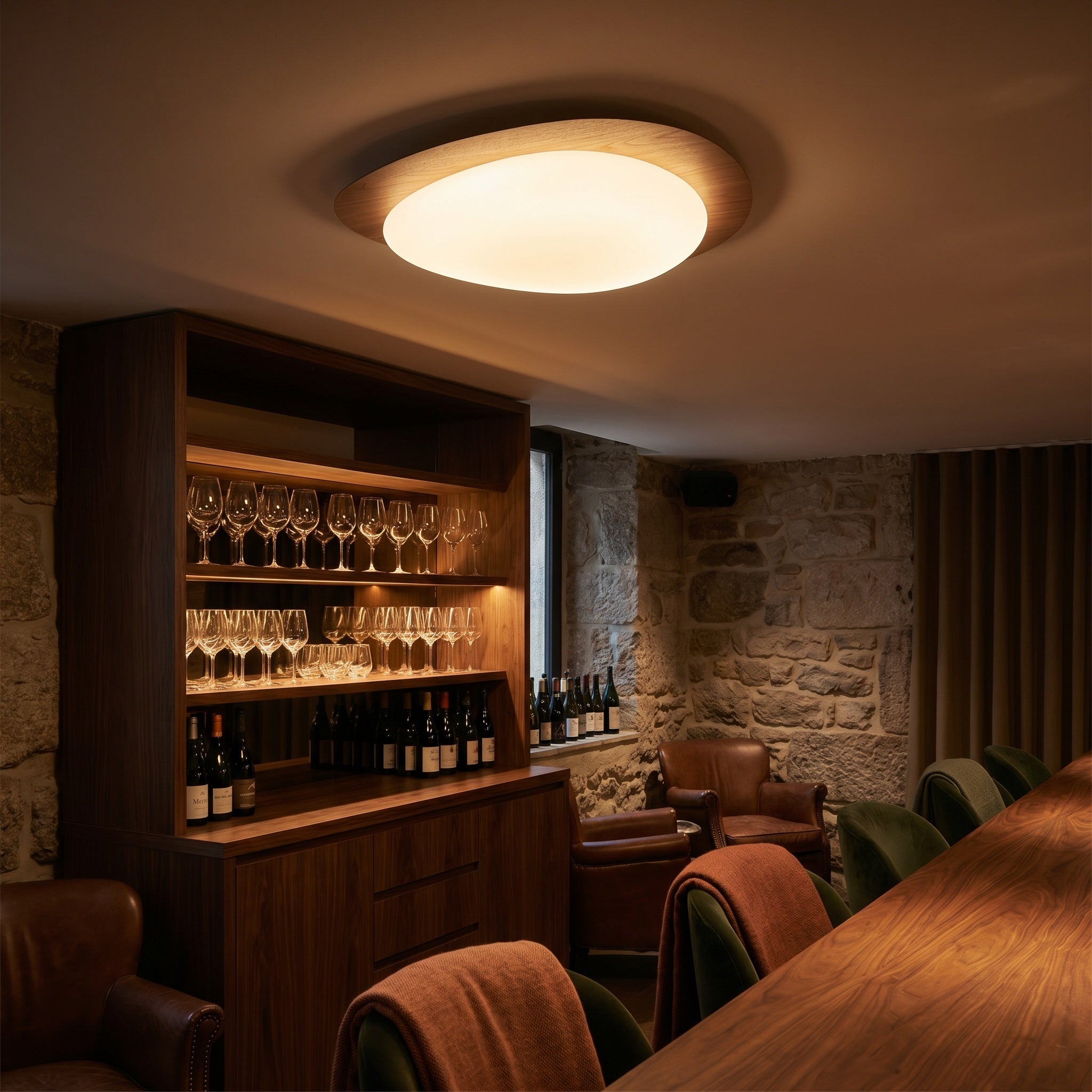 Ericeira pebble form flush mount ceiling light above a dining table in a bright kitchen
