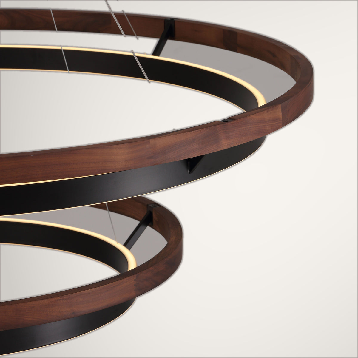 Espargos circular ceiling light, the walnut outer ring meeting the black lit inner ring.