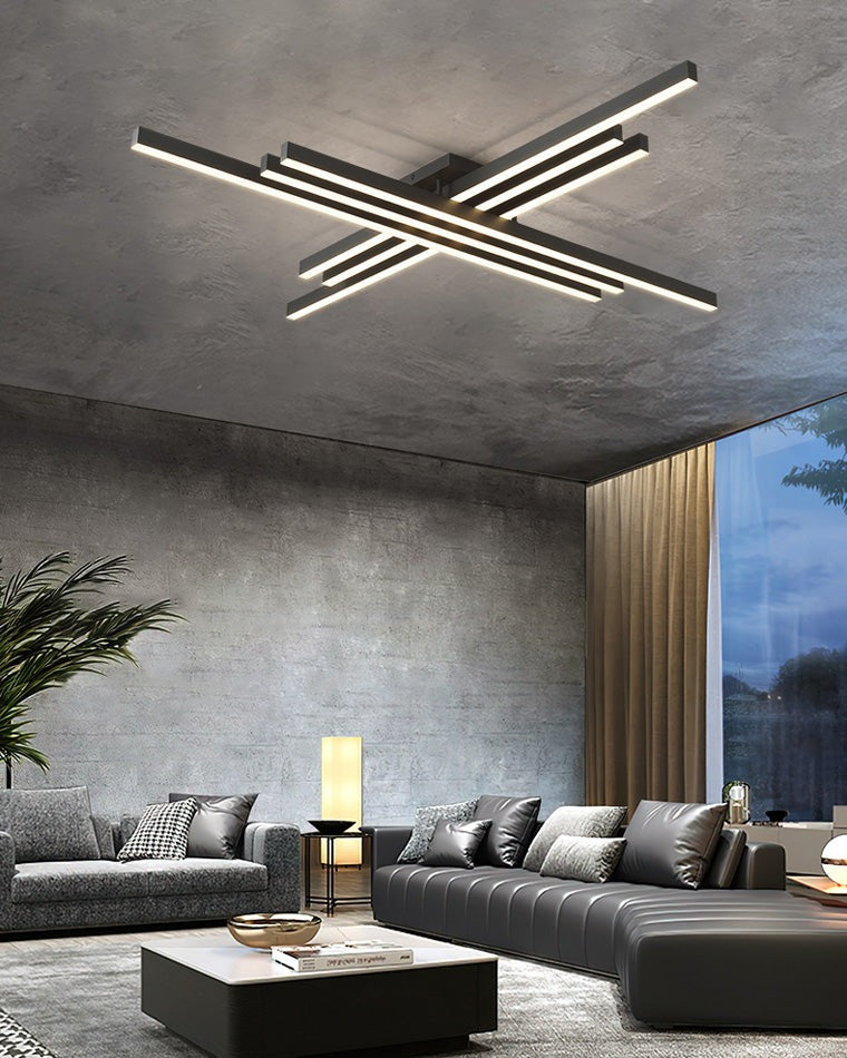 Esposende linear flush mount ceiling light, in a living room, by a full height window at dusk.