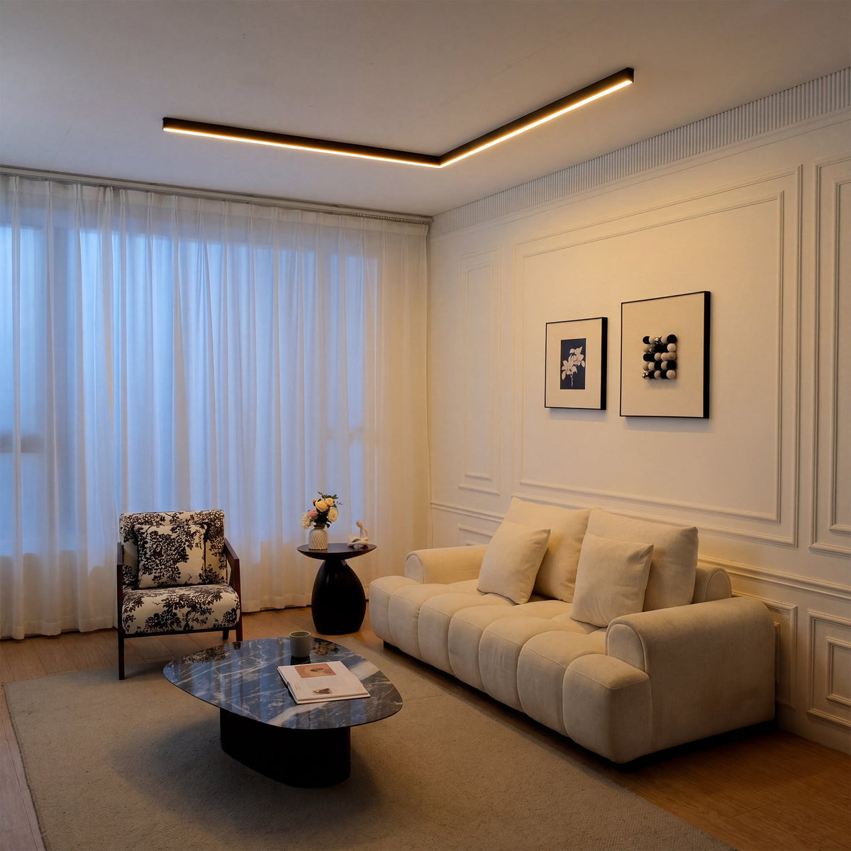 Estarreja linear ceiling light, in a living room, above a curved sofa.