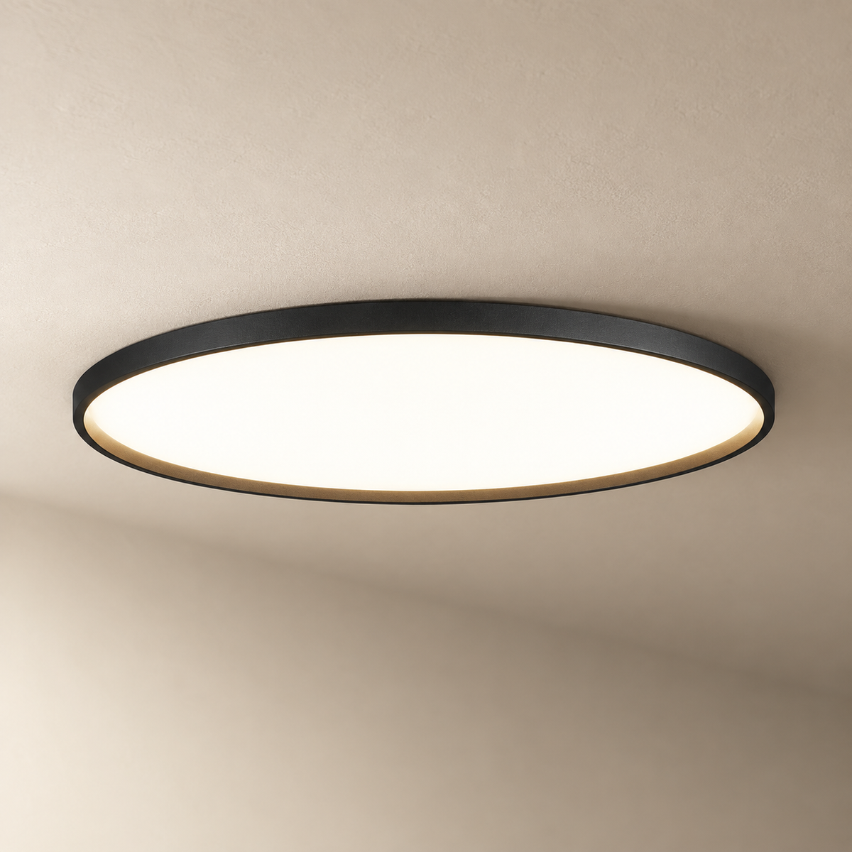 Estorãos flat round flush mount ceiling light in black, on a plain ceiling.