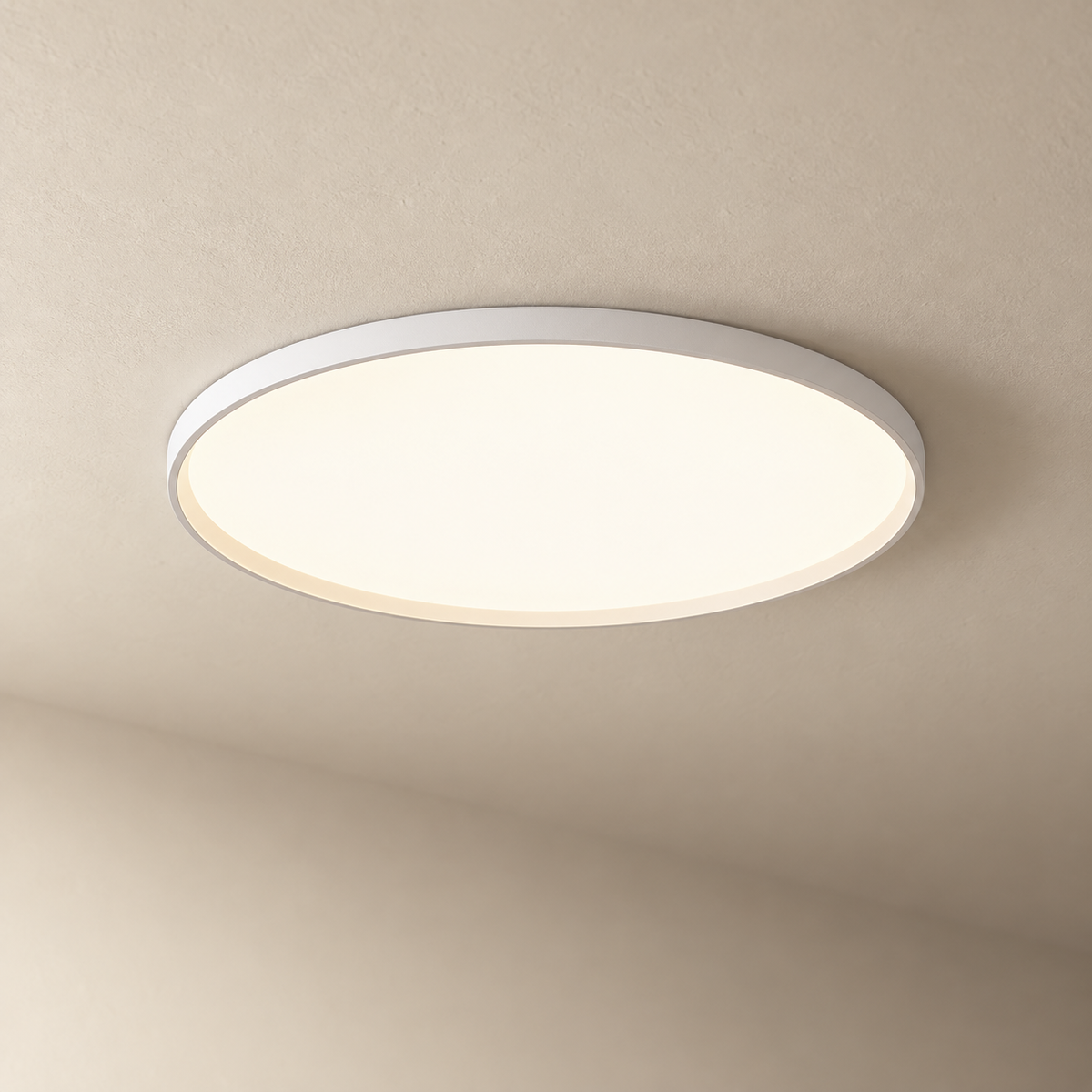 Estorãos flat round flush mount ceiling light in white, on a plain ceiling.
