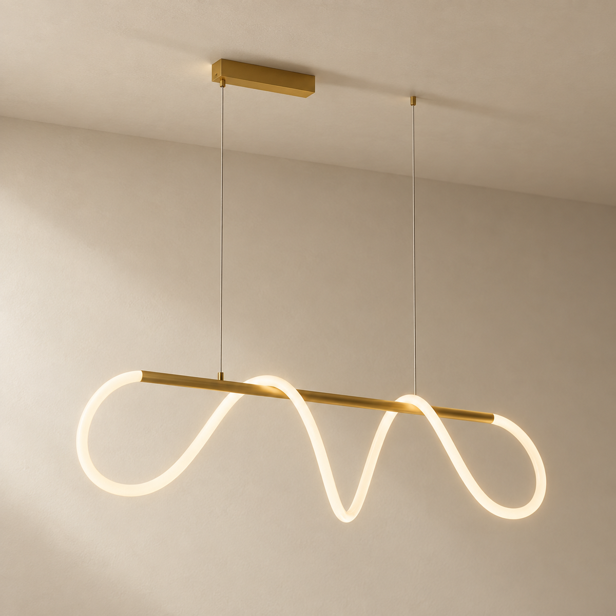 Fátima linear hose pendant light in polished brass, on a plain ceiling.