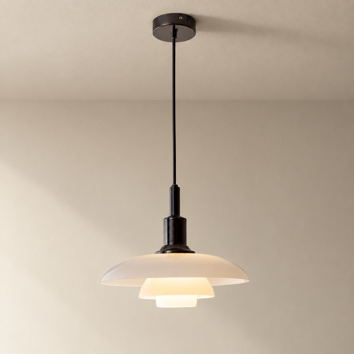 Fundão round ceiling light in black, on a plain ceiling.