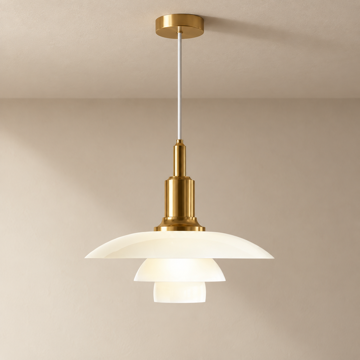 Fundão round ceiling light in gold, on a plain ceiling.