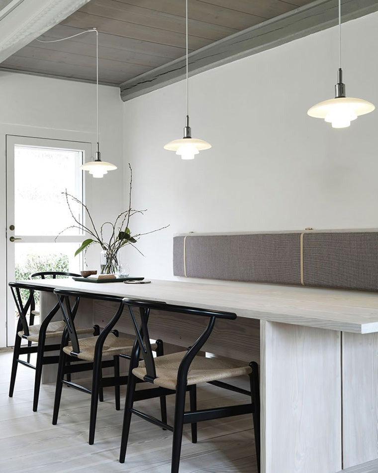 Fundão round ceiling light, in a dining room, in a row above a long table.