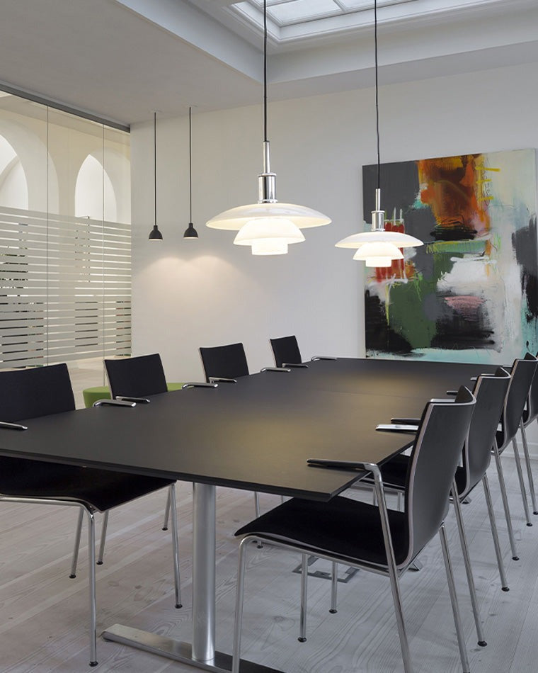 Fundão round ceiling light, in a home office, above a boardroom table.