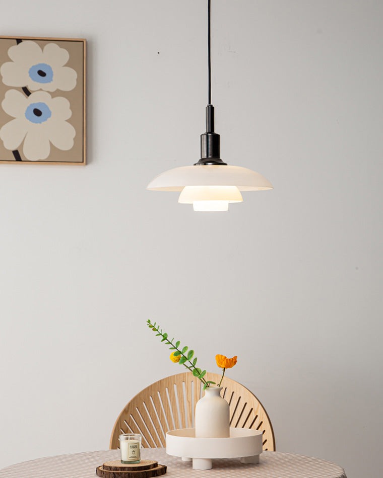 Fundão round ceiling light, in a dining room, above a fan backed chair.