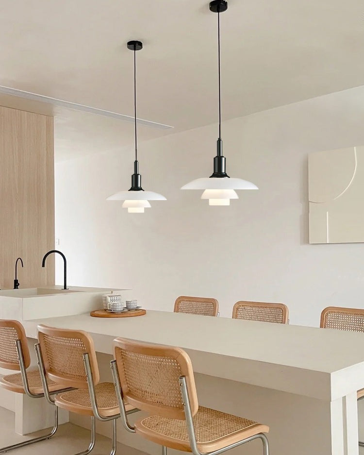 Fundão round ceiling light, in a kitchen, above rattan stools.