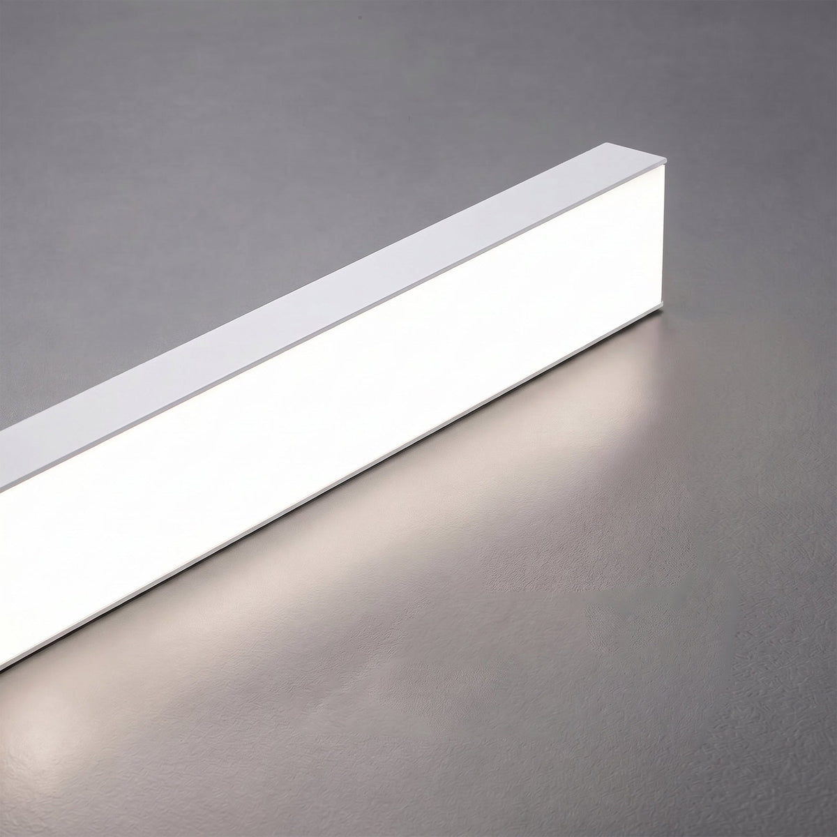 Góis linear LED ceiling light, close detail of the finish and fittings, angled, showing the light line.