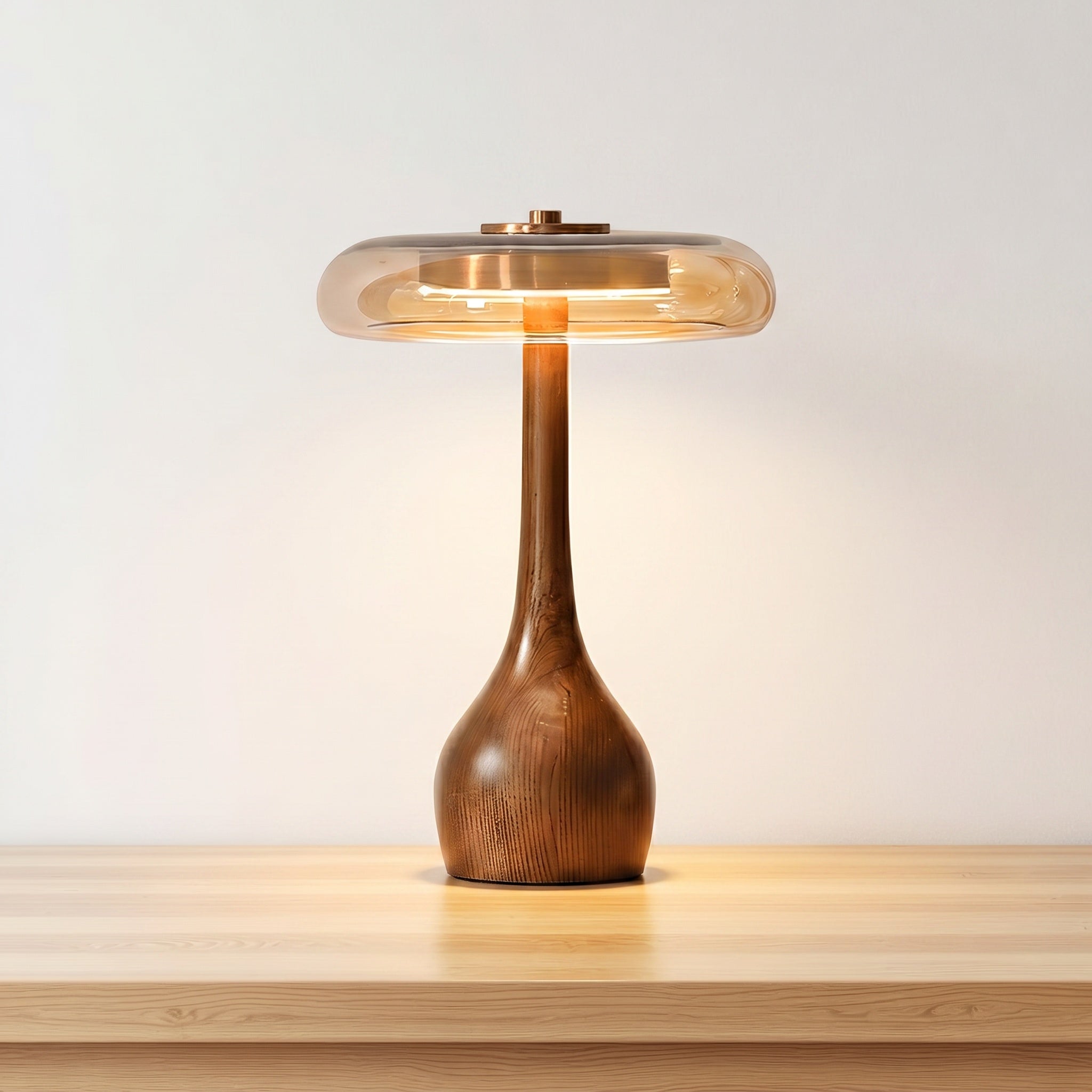 Wooden table lamp with walnut-finished teardrop base and amber glass dome, taller version, product shot.