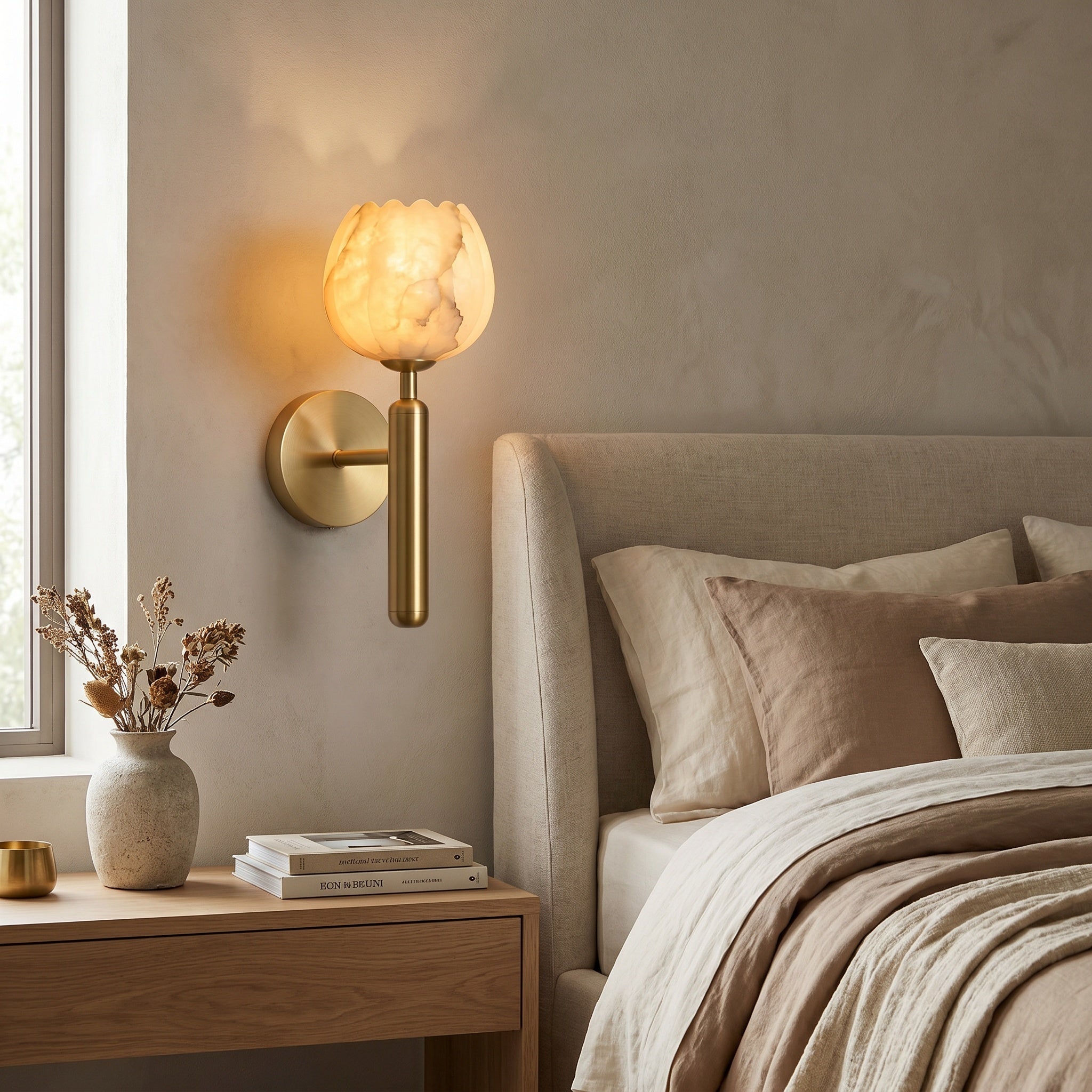 Mértola brass-finish sconce mounted above a sideboard, warm petal glow in the room