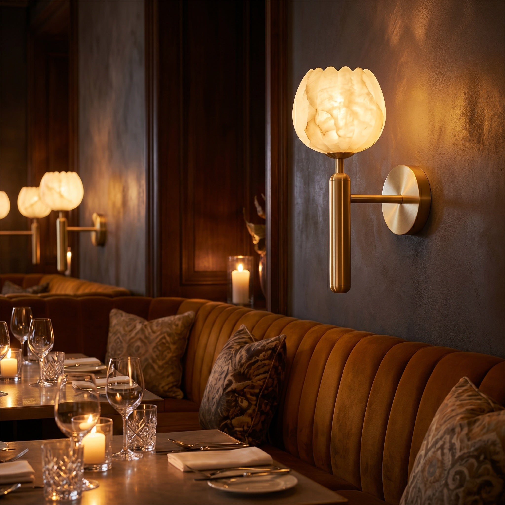 Mértola brass-finish sconce on a hallway wall, soft light spreading across the plaster