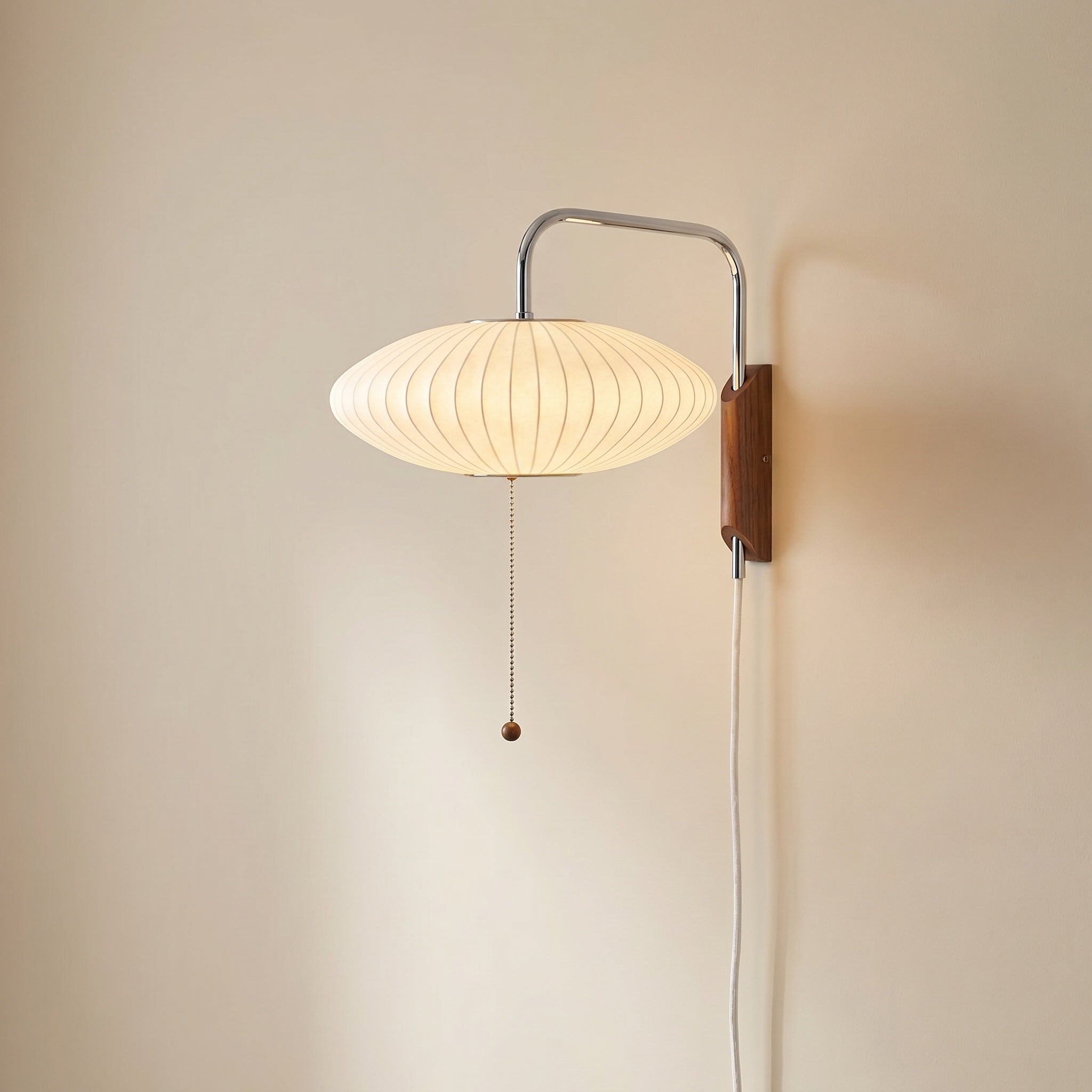 Mirandela globe wall sconce side angle showing chrome arm and walnut wood detail