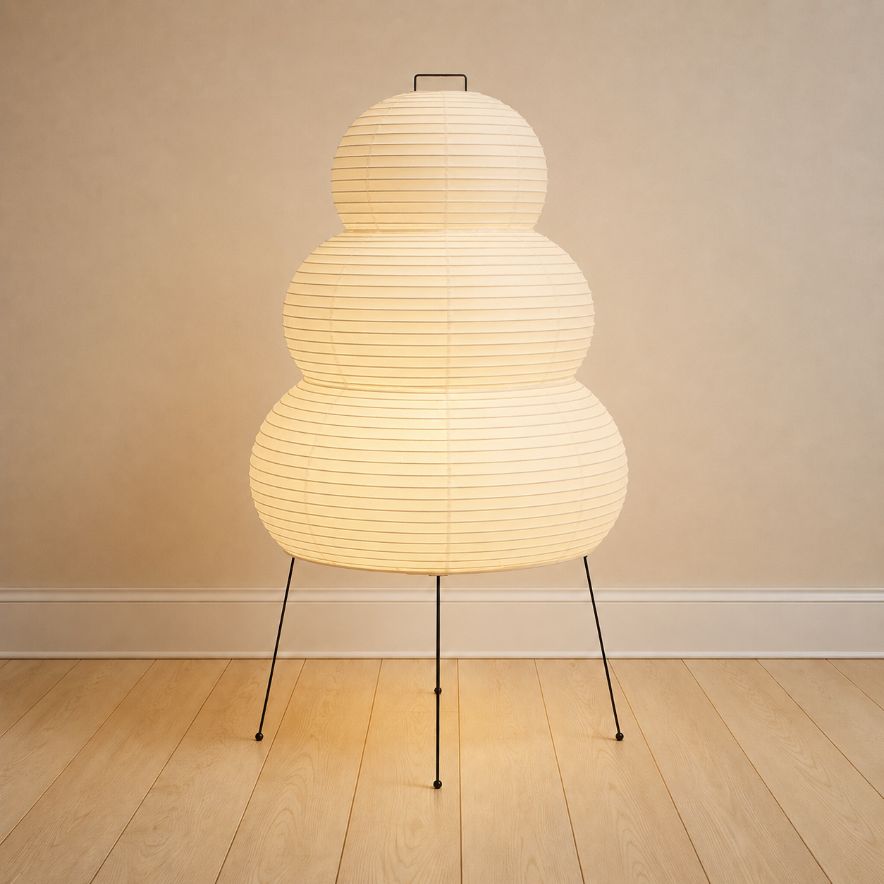 Mulberry paper table lamp, large stacked form, on a black metal tripod.