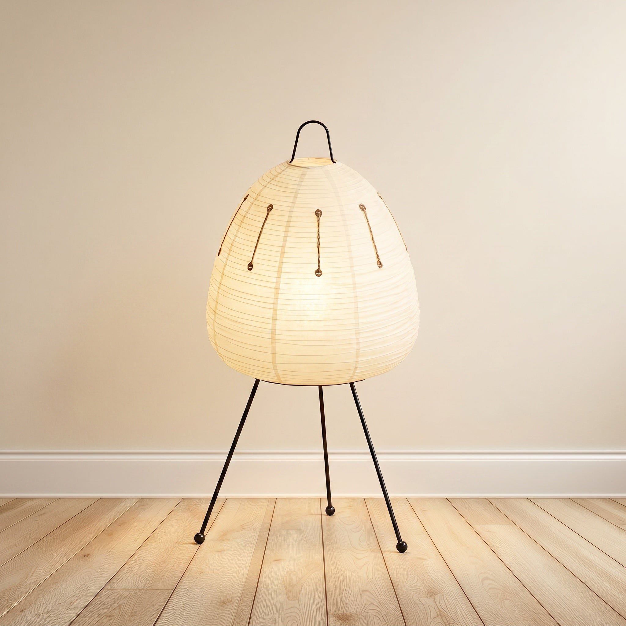 Mulberry paper table lamp, faceted column form, on a black metal tripod.