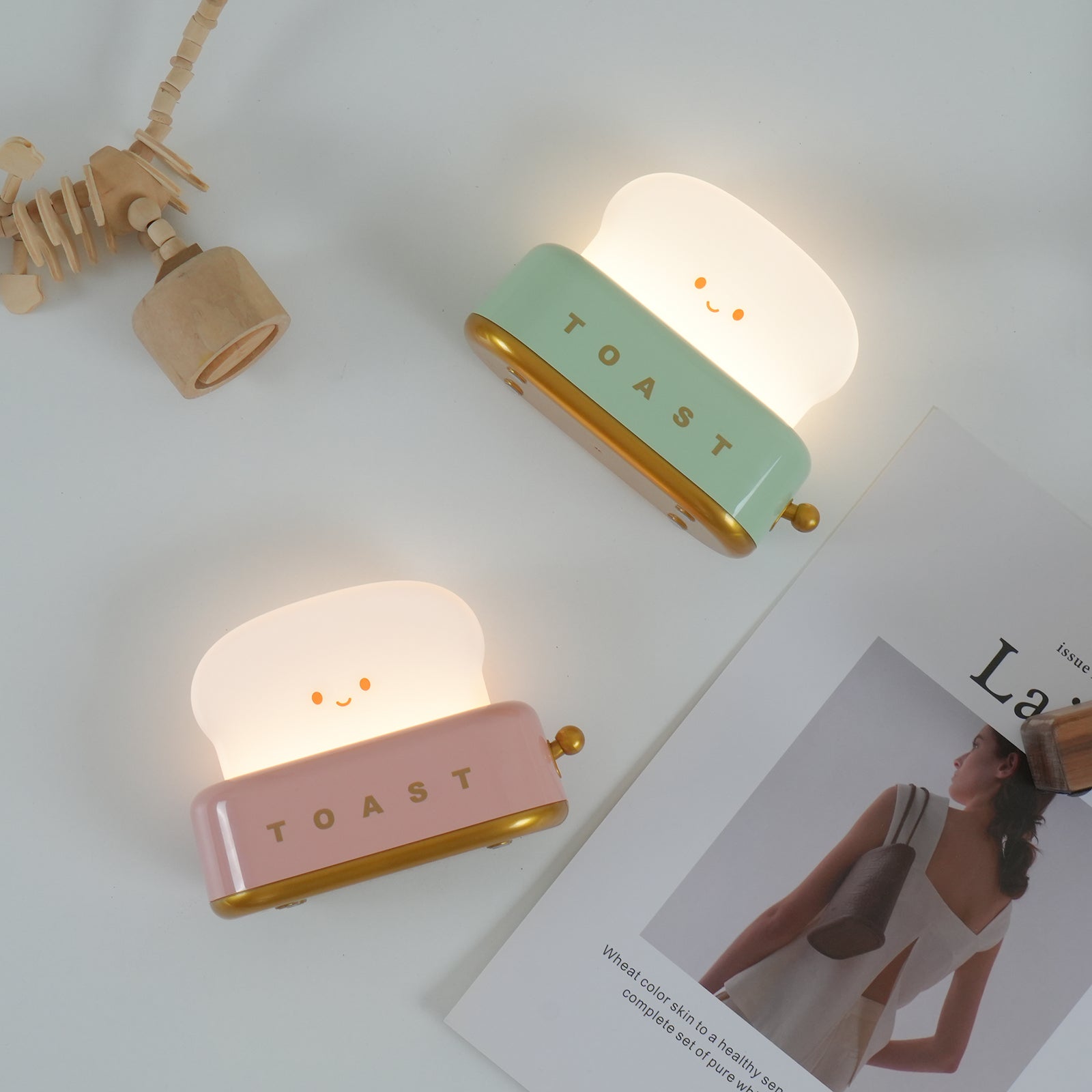 Toaster-shape LED night light beside coffee on a table.
