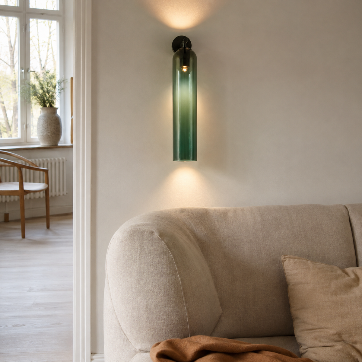 Sortelha mouthblown glass wall sconce, black fitting, in a living room.