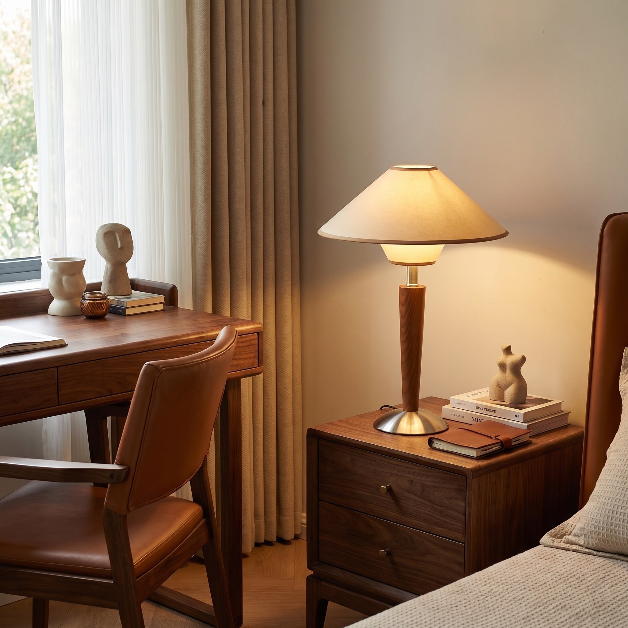 Walnut wooden table lamp with beige shade beside a wood writing desk.