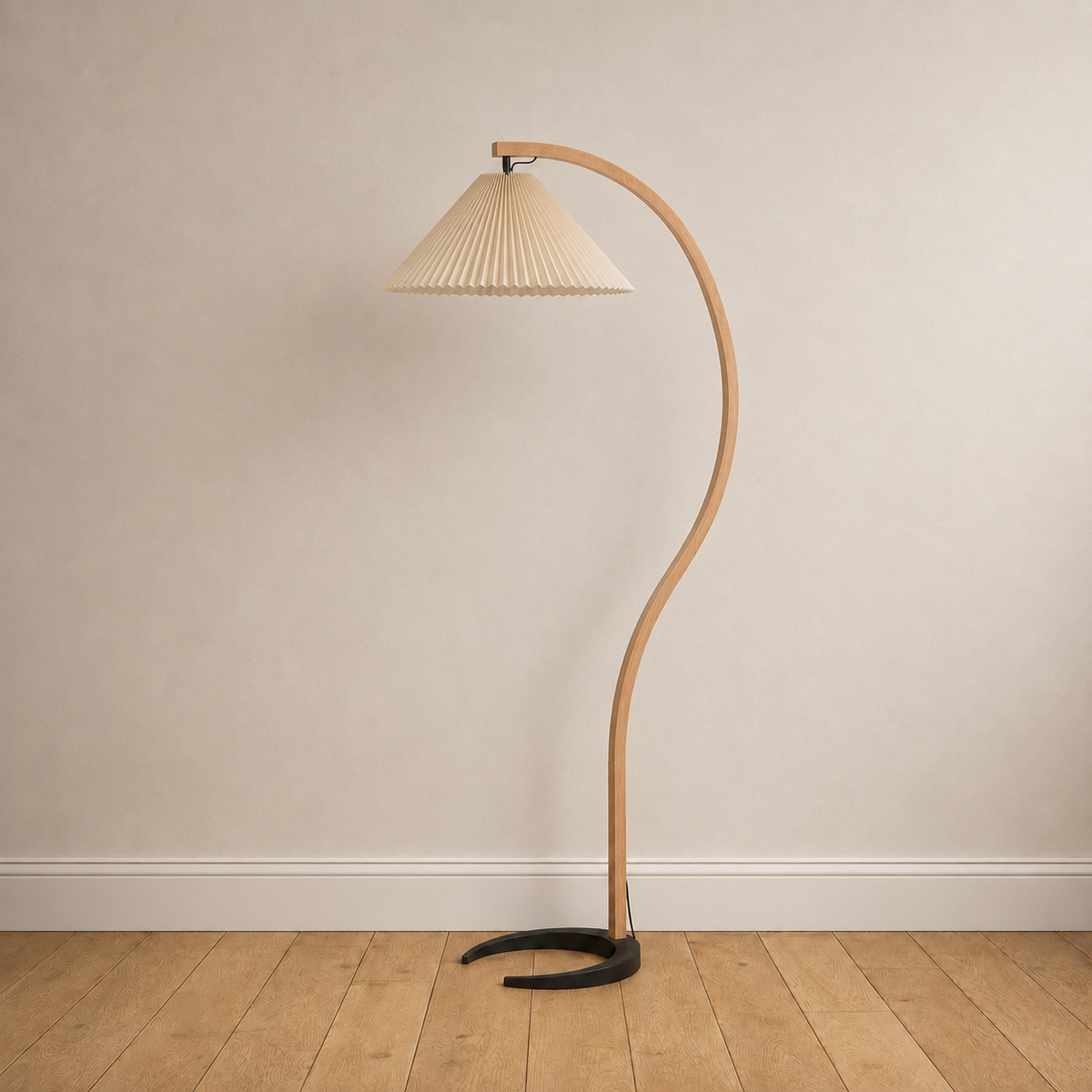 Bentwood beech floor lamp with a pleated beige linen shade, unlit, on a plain wall over wood floors.