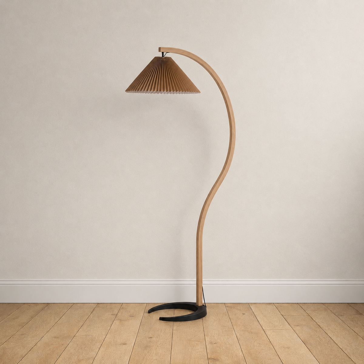 Bentwood beech floor lamp with a pleated coffee linen shade, unlit, on a plain wall over wood floors.