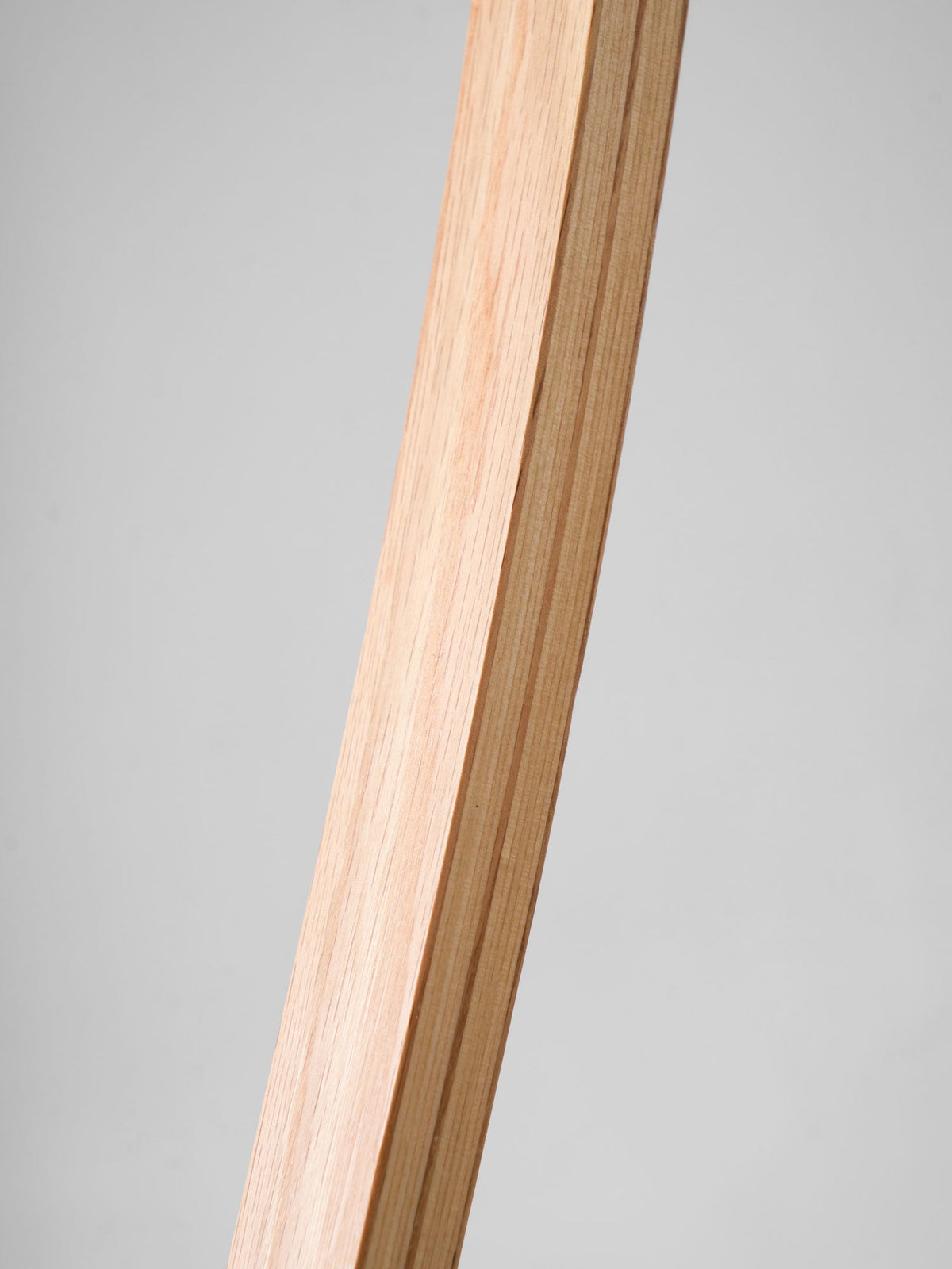 Laminated bentwood beech arm in close-up showing layered grain.