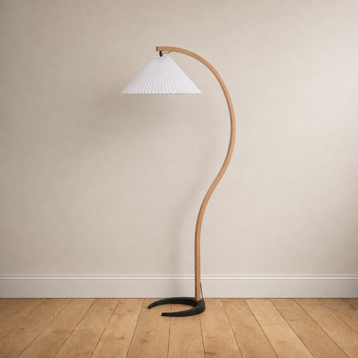 Bentwood beech floor lamp with a pleated white linen shade, unlit, on a plain wall over wood floors.